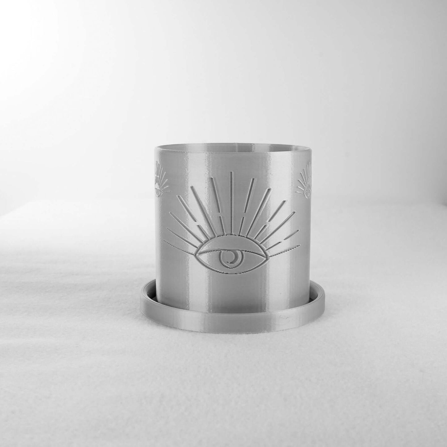 All-Seeing Eye Planter in metallic finish featuring intricate eye design, showcasing goth vibes, with excellent drainage for plant lovers, available in multiple sizes and colors to enhance your home decor. Ideal for superior plant care and eco-friendly living. 3D printed with biodegradable PLA.