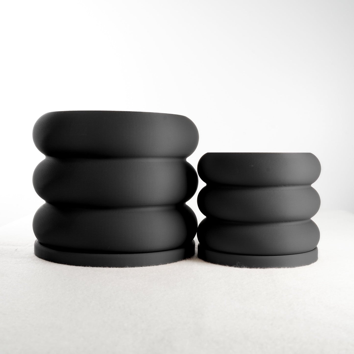 Modern, whimsical Bubble Planter/Donut Planter with excellent drainage, displayed in sleek matte black finish, perfect for plant lovers and home decor enthusiasts.