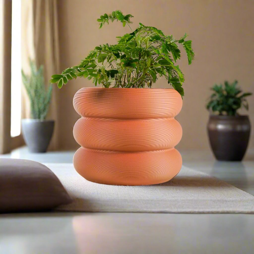 Bubble Planter/Donut Planter with Drainage in a terracotta matte finish, featuring a whimsical, donut-like design with lush green plant, perfect for plant lovers and home decor enthusiasts. Excellent drainage for healthy plants, available in multiple colors and sizes.
