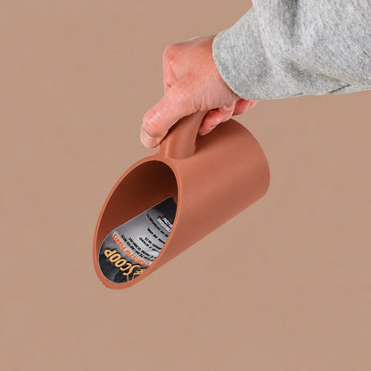 Terracotta-colored soil scoop for repotting plants, shown held in one hand.