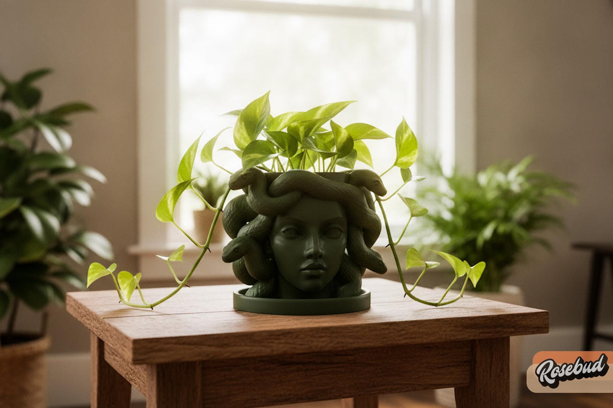 Green Medusa snake planter with trailing pothos plant and matching drip tray on a wood table