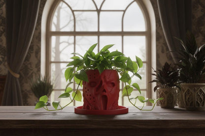 Red horror-inspired face planter with trailing pothos and matching drip tray in gothic home decor.
